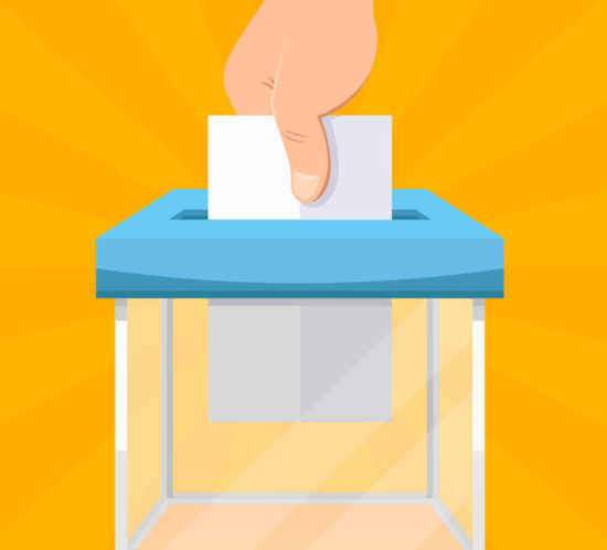 A hand putting a vote into a box